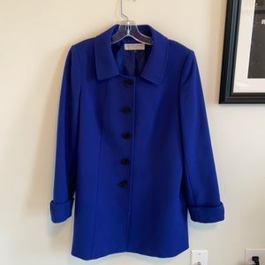 Long royal blue jacket with black buttons and cuff sleeves. Detailed seam work.